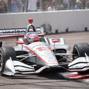 white and red f 1 car on road