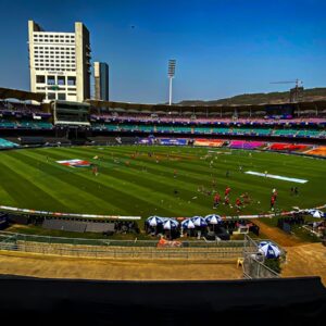 a sports field with a crowd of people in the stands