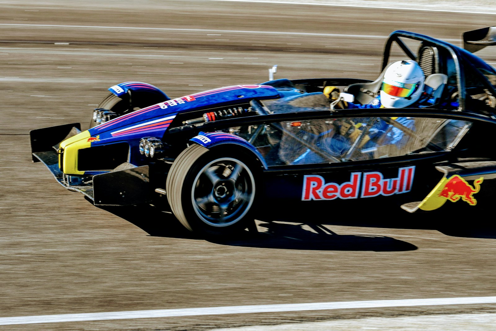 a man driving a race car on a track